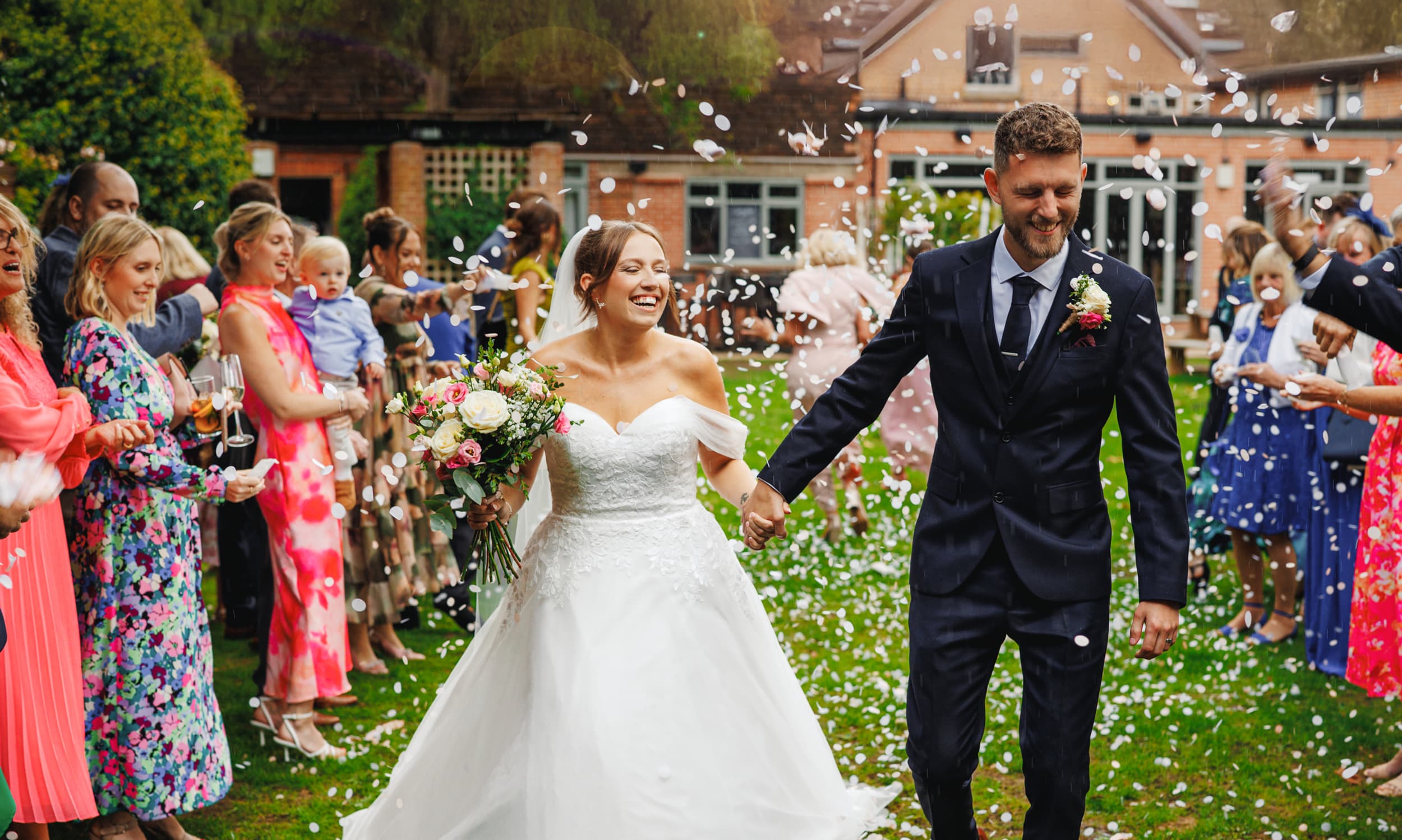 Wedding guests throwing confetti